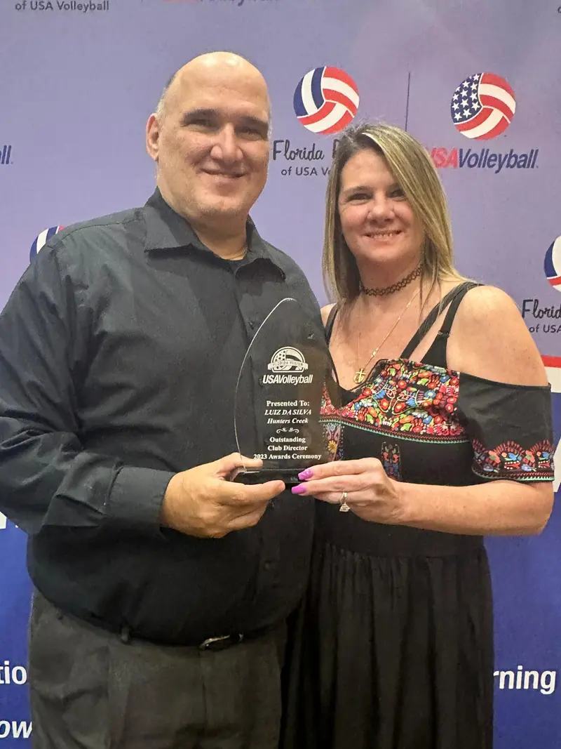 The club founders holding their USA Volleyball Florida Region award
